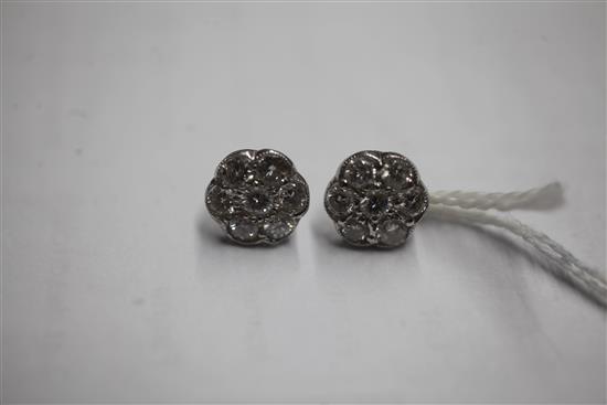 A pair of platinum and diamond seven-stone cluster ear studs, 12mm.